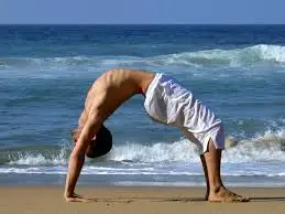 Yoga backbend on the beach